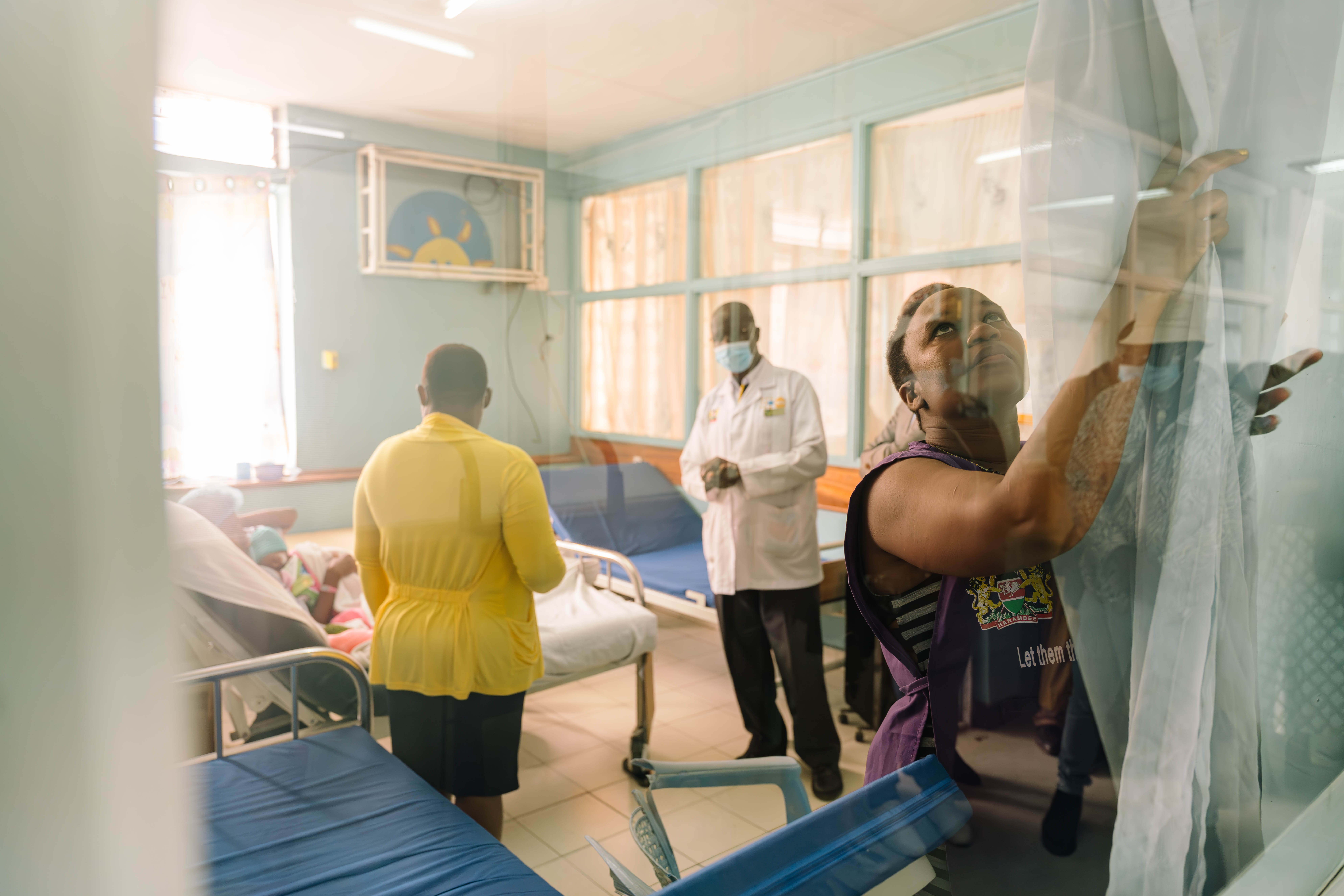 Caregivers and medical staff inside a hospital ward